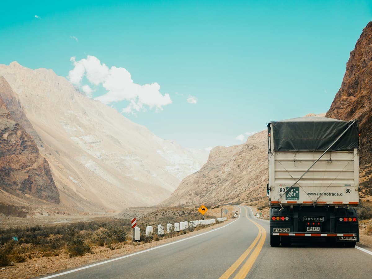 A haulage trailer travelling a two-lane highway through open country